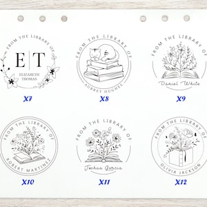 May include: A collection of six circular library stamps with floral and book designs. Each stamp features the phrase "From the Library of" and a personalized name. The stamps are in black ink on a white background.