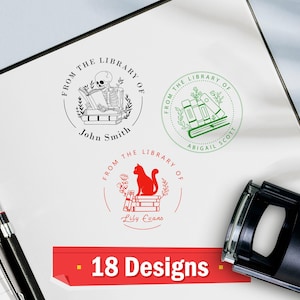 May include: Three custom library stamps with unique designs. One features a skeleton reading, another has stacked books, and the third showcases a cat on books. The stamps are in black, green, and red ink, with names below. The image also shows the text "18 Designs".