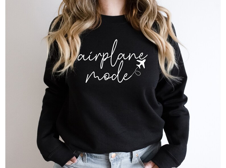 a woman wearing a black sweatshirt that says air force mode