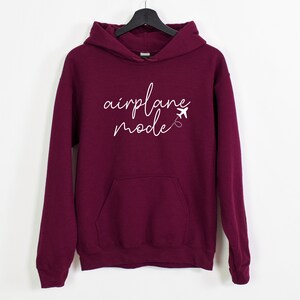 a maroon sweatshirt with the words applique made written on it