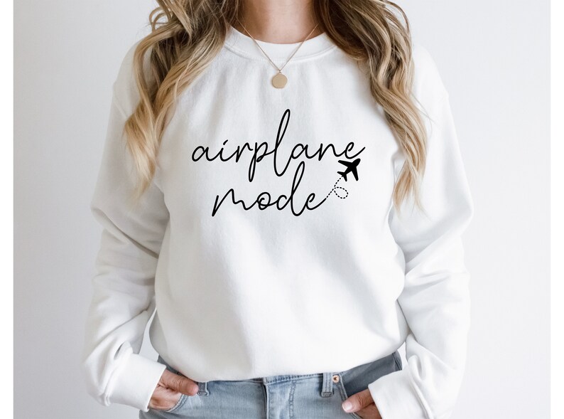 a woman wearing a white sweatshirt with the words airplane model printed on it