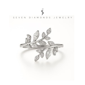 Può includere: Un anello d'argento con un design a foglie, con diamanti taglio marquise e rotondi. La fascia dell'anello si curva attorno al dito, con le foglie che si estendono verso l'esterno. Il testo "SEVEN DIAMONDS JEWELRY" è sopra.
