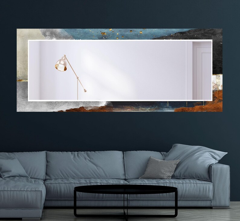 a living room with a couch and a painting on the wall