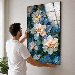 Glossy tempered glass artwork displaying layered white blossoms across a rich blue botanical scene.