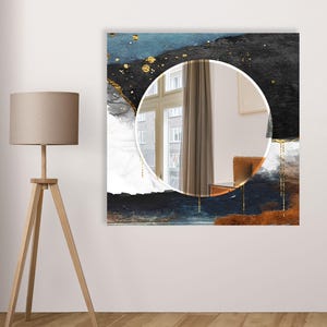 a mirror hanging on a wall next to a lamp