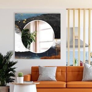 a living room with a couch and a painting on the wall
