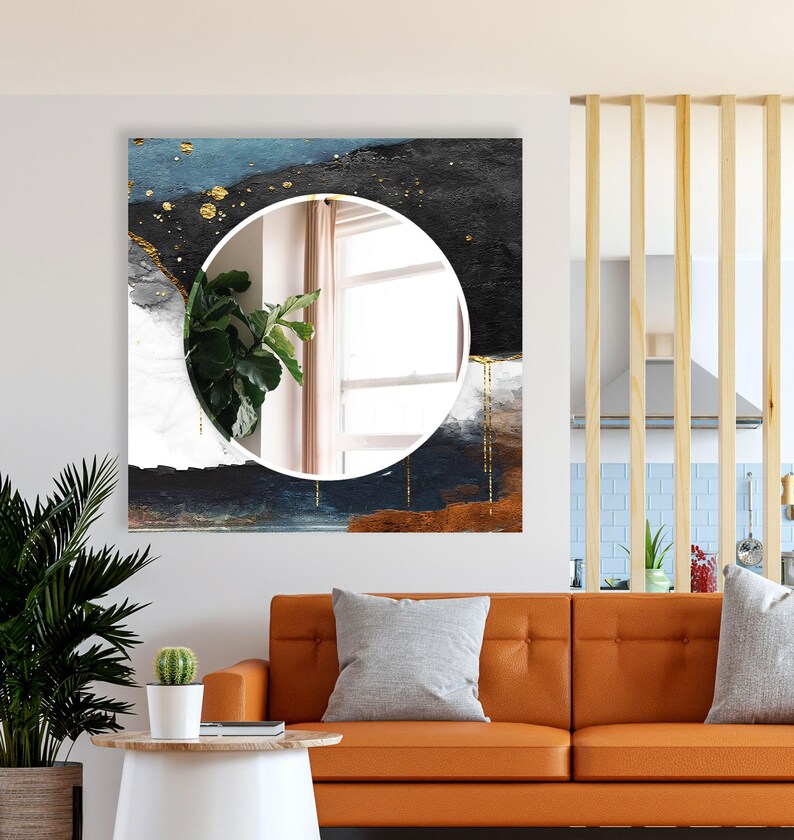 a living room with a couch and a painting on the wall