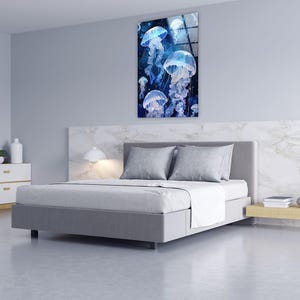 a bedroom with a bed and a painting on the wall