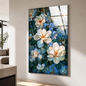 Vertical tempered glass wall art featuring white magnolia blossoms against a layered blue background.