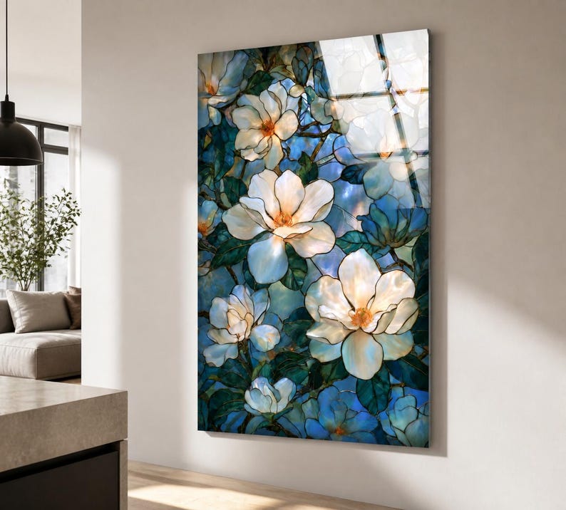 Vertical tempered glass wall art featuring white magnolia blossoms against a layered blue background.
