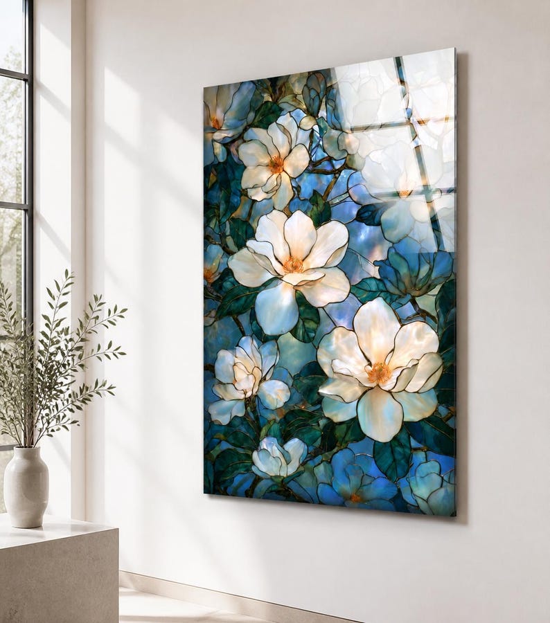 Ready-to-hang vertical glass artwork with white magnolia flowers and a cool blue garden background.