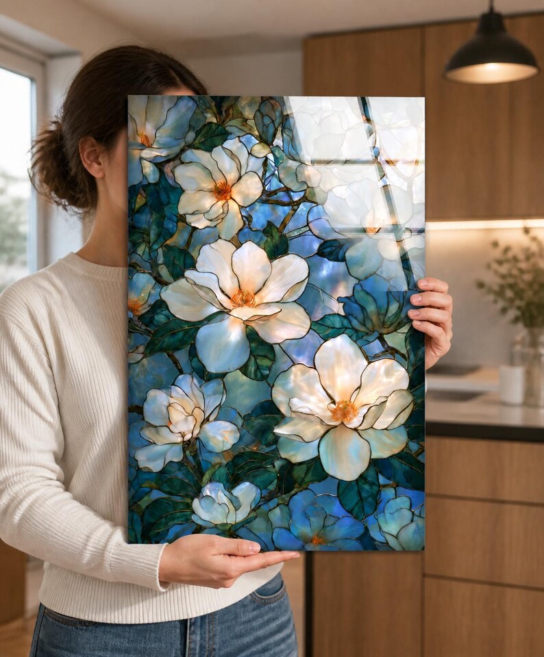 Framed or unframed magnolia glass wall art with ivory flowers and dark teal foliage.