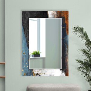 a mirror on a wall with a plant in it