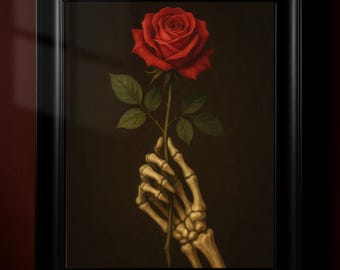 May include: Framed artwork depicting a red rose held by a skeletal hand against a dark backdrop. The rose has green leaves and a thorny stem. The artwork is presented in a black frame.