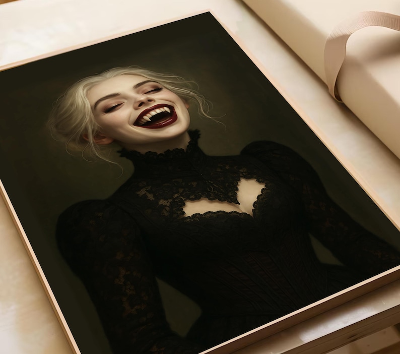 May include: A framed portrait of a woman with pale skin and blonde hair, laughing with fangs visible. She wears a black lace dress with a high collar and a cutout at the chest. The artwork has a dark, gothic aesthetic.