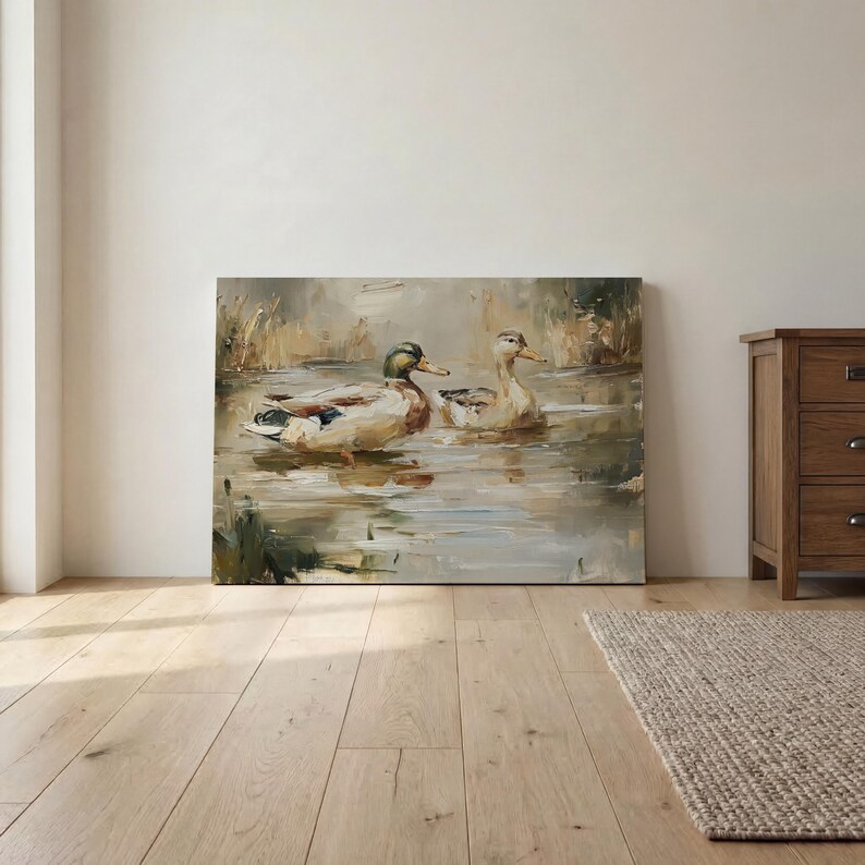 a large painting of two ducks swimming in a pond, displayed on a wall in a room with a wooden floor.