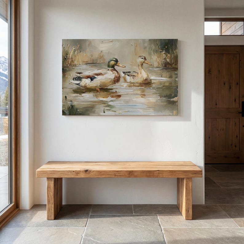a wooden bench situated in a room with a large painting of ducks on the wall above it.