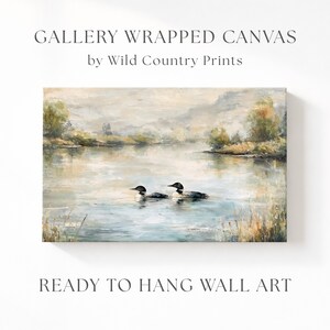 The image is a painting of two loon birds swimming in a lake, surrounded by trees and a cloudy sky.
