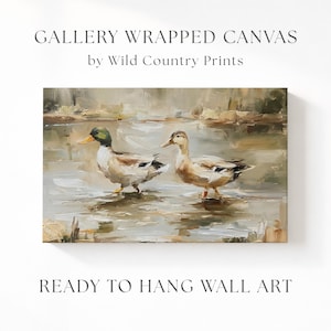 The image is a painting of two ducks in a body of water, with the text "Gallery Wrapped Canvas by Wild Country Prints" and "Ready to Hang Wall Art" below it.