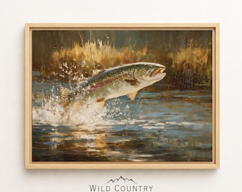 Puede incluir: Una pintura al óleo en un marco de madera clara que muestra una trucha saltando del agua azul, creando un chapoteo blanco. El fondo presenta juncos de color marrón dorado y sombras oscuras. Debajo, el texto dice Wild Country Collective.