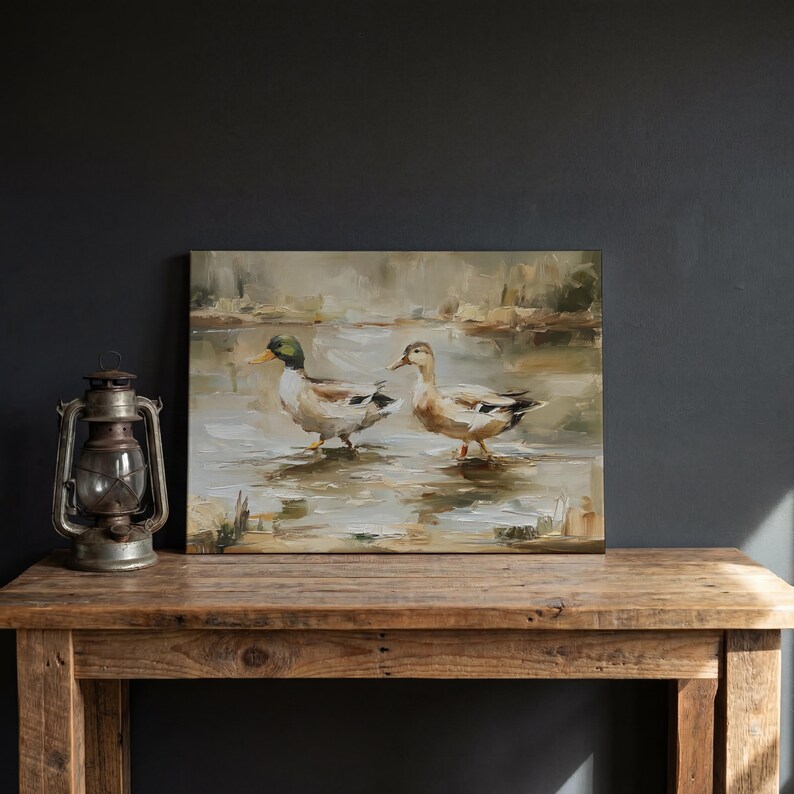 a painting of two ducks in a pond, displayed on a wooden table.