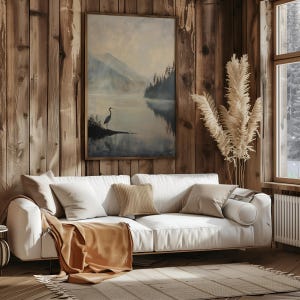 a living room filled with furniture and a painting on the wall