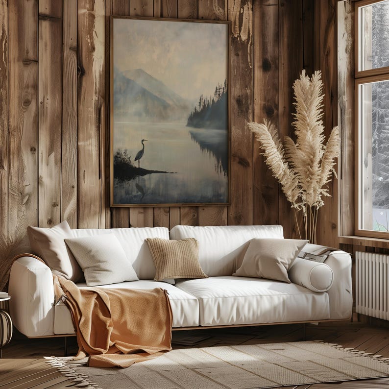 a living room filled with furniture and a painting on the wall