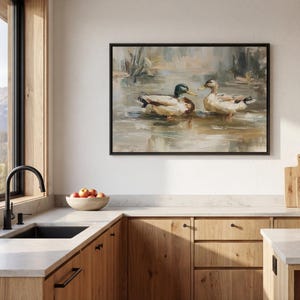 a kitchen with a large painting of ducks swimming on the wall above a sink. The kitchen has wooden cabinets and a countertop, and there is a bowl of fruit on the counter.