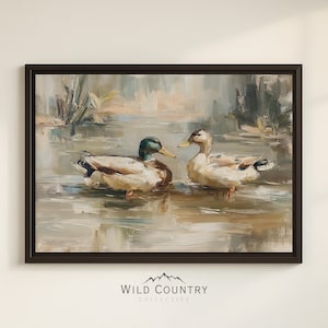 The image is a framed painting depicting two ducks swimming in a body of water, surrounded by a natural landscape.