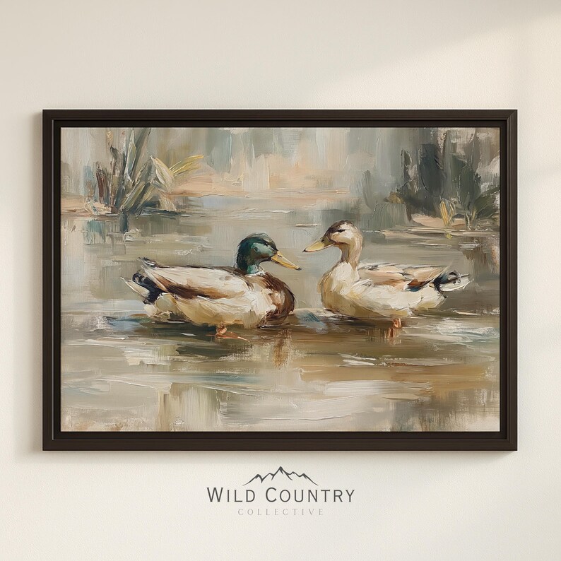 The image is a framed painting depicting two ducks swimming in a body of water, surrounded by a natural landscape.
