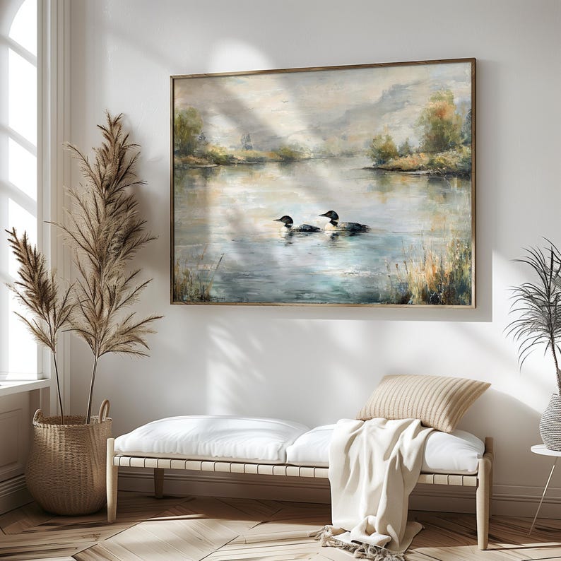 a serene indoor setting with a large painting of two ducks swimming on a lake hanging on the wall. The painting is framed in a white frame and is the focal point of the room. The room also features a bench, a potted plant, and a decorative vase, creating a cozy and inviting atmosphere.