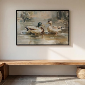 a large painting of two ducks swimming in a pond, hanging on a wall above a wooden bench.