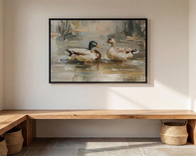 a large painting of two ducks swimming in a pond, hanging on a wall above a wooden bench.