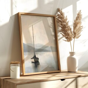 a picture of a sailboat in a frame on a shelf
