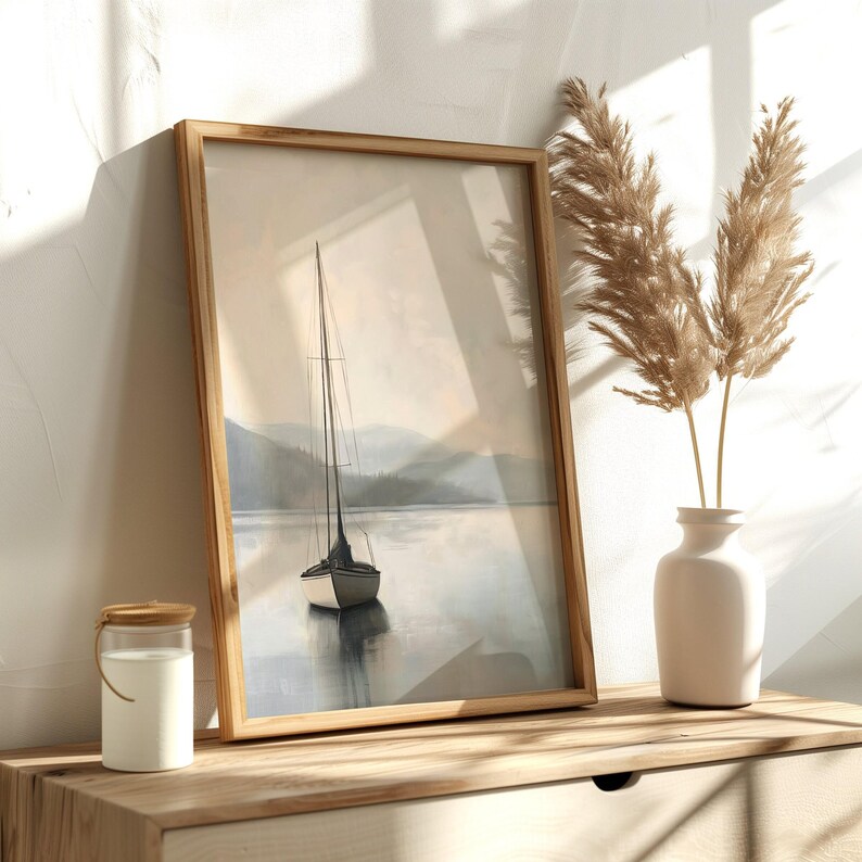 a picture of a sailboat in a frame on a shelf