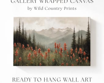 May include: A gallery wrapped canvas by Wild Country Prints featuring a landscape painting of orange wildflowers in the foreground with dark green pine trees and misty mountains in the background. The text reads GALLERY WRAPPED CANVAS by Wild Country Prints and READY TO HANG WALL ART.