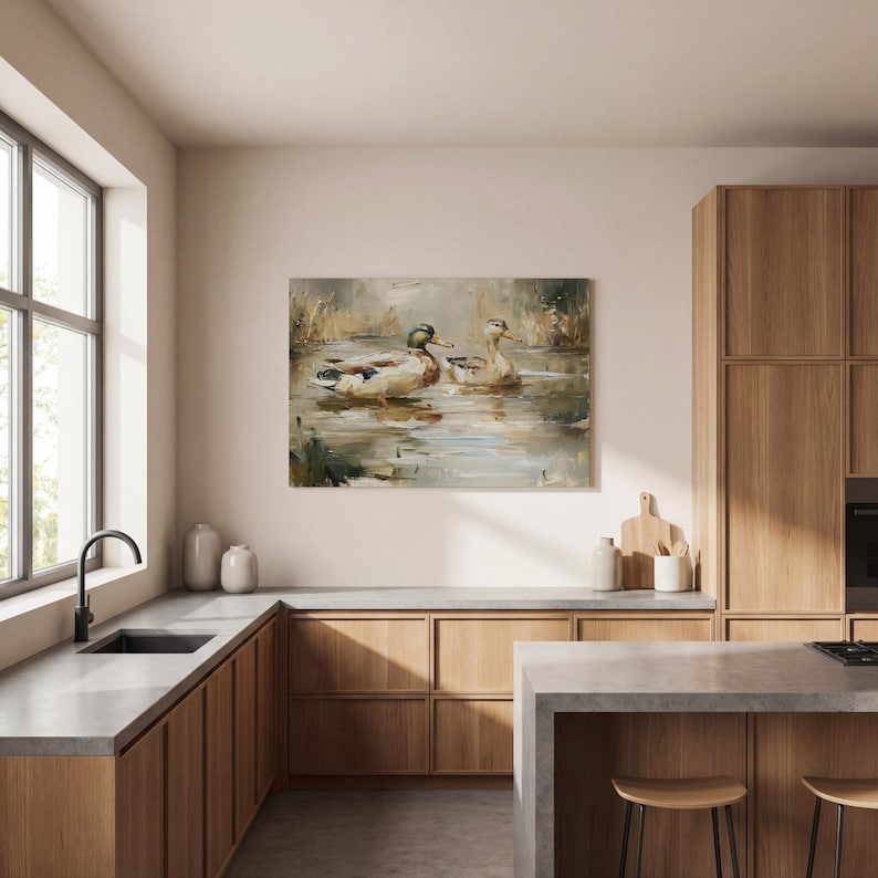 a modern kitchen with wooden cabinets, a large window, and a painting of ducks swimming in a pond hanging on the wall.