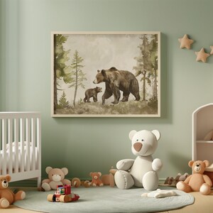 May include: A framed watercolor painting of a brown bear and a cub walking through a forest. The painting has a light brown background with green trees and a light blue sky.