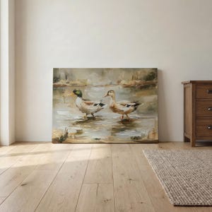 a large painting of two ducks standing in a body of water, with a wooden floor and a wooden dresser visible in the background.