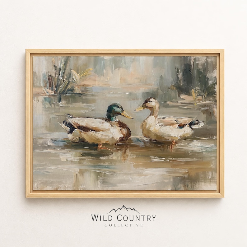 The image is a framed painting depicting two ducks swimming in a body of water, surrounded by a natural landscape.