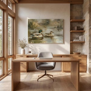 a serene and modern workspace with a large painting of ducks on a lake hanging on the wall, a wooden desk with a chair, and a vase of flowers on the desk.