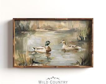 May include: A framed oil painting depicts two ducks swimming in a pond. The male duck has a green head and brown body, while the female is brown. The artwork is in a wooden frame.