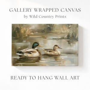 The image is a painting of two ducks swimming in a pond, with a text overlay that reads "Gallery Wrapped Canvas by Wild Country Prints" and "Ready to Hang Wall Art".