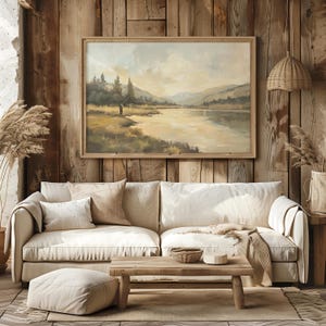 a living room with a couch and a painting on the wall