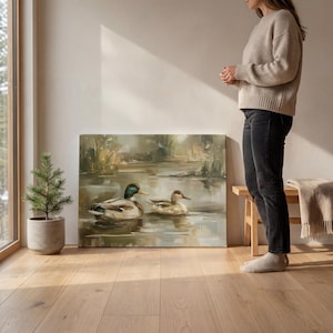 A woman stands in a room with a large painting of ducks on a wooden floor, next to a potted plant and a wooden bench.