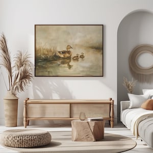a living room with a couch and a painting on the wall