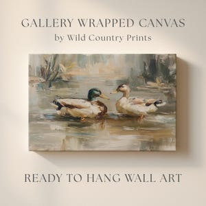 The image is a painting of two ducks swimming in a body of water, with the text "GALLERY WRAPPED CANVAS by Wild Country Prints" and "READY TO HANG WALL ART" below it.