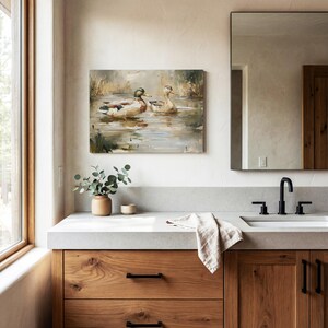 a bathroom with a large mirror, a wooden vanity, and a painting of ducks on the wall.