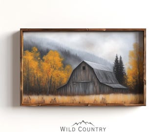 May include: A rectangular wall art piece featuring a landscape painting of a rustic wooden barn surrounded by golden autumn trees and a misty mountain backdrop, all enclosed within a dark brown wooden frame with the text Wild Country Collective.
