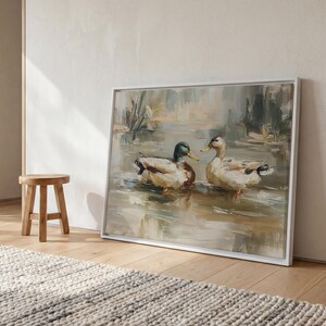 a large painting of two ducks swimming in a pond, displayed on a wall in a room with a wooden stool and a rug.